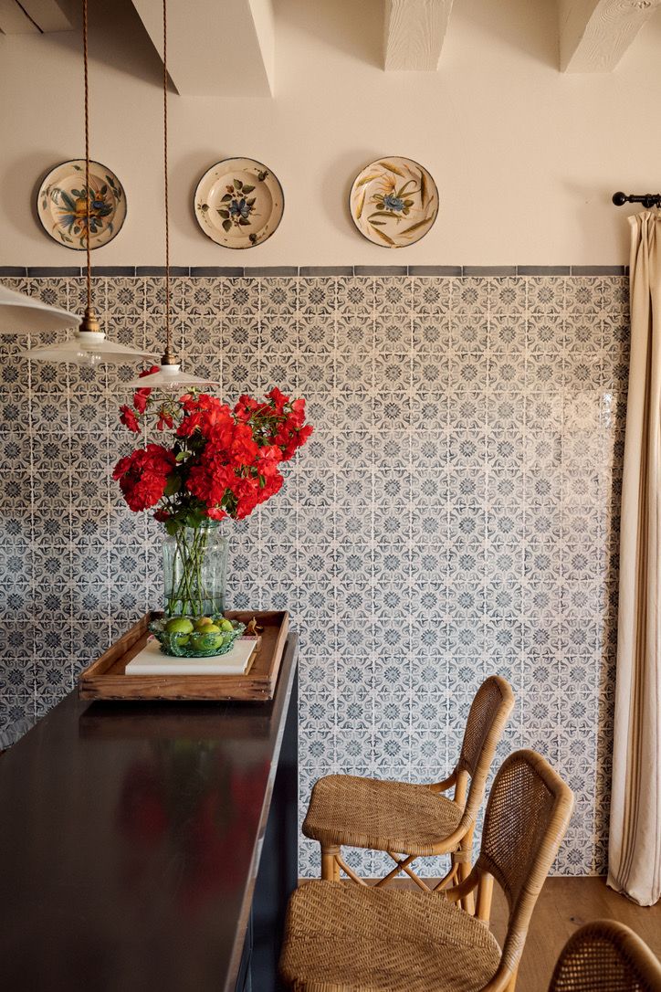 Patterned tiles and rattan stools in the kitchen