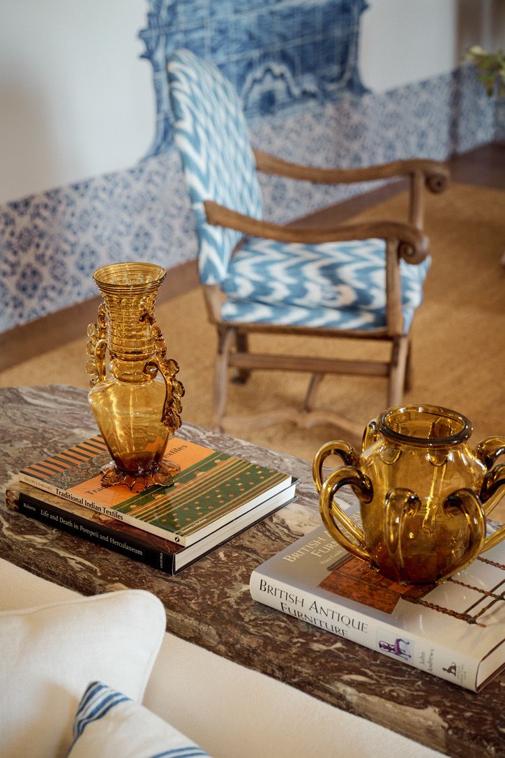 Amber glass and books on a marble table in the sitting room