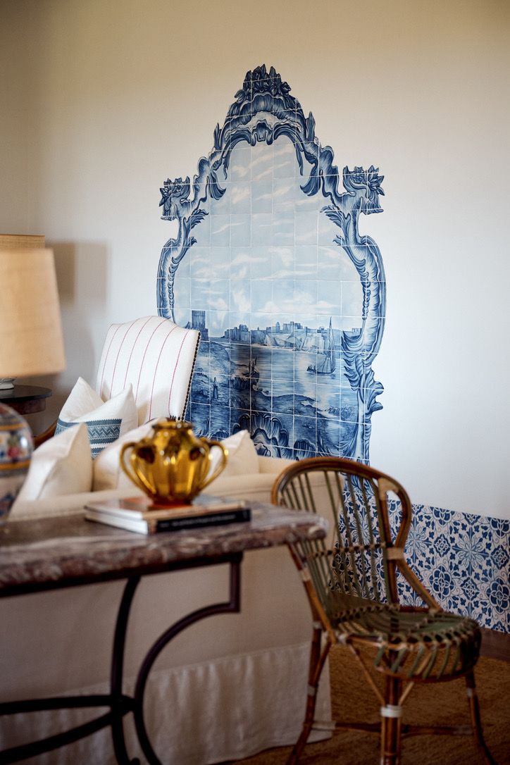 A blue-and-white tiled panel behind the sitting room sofa