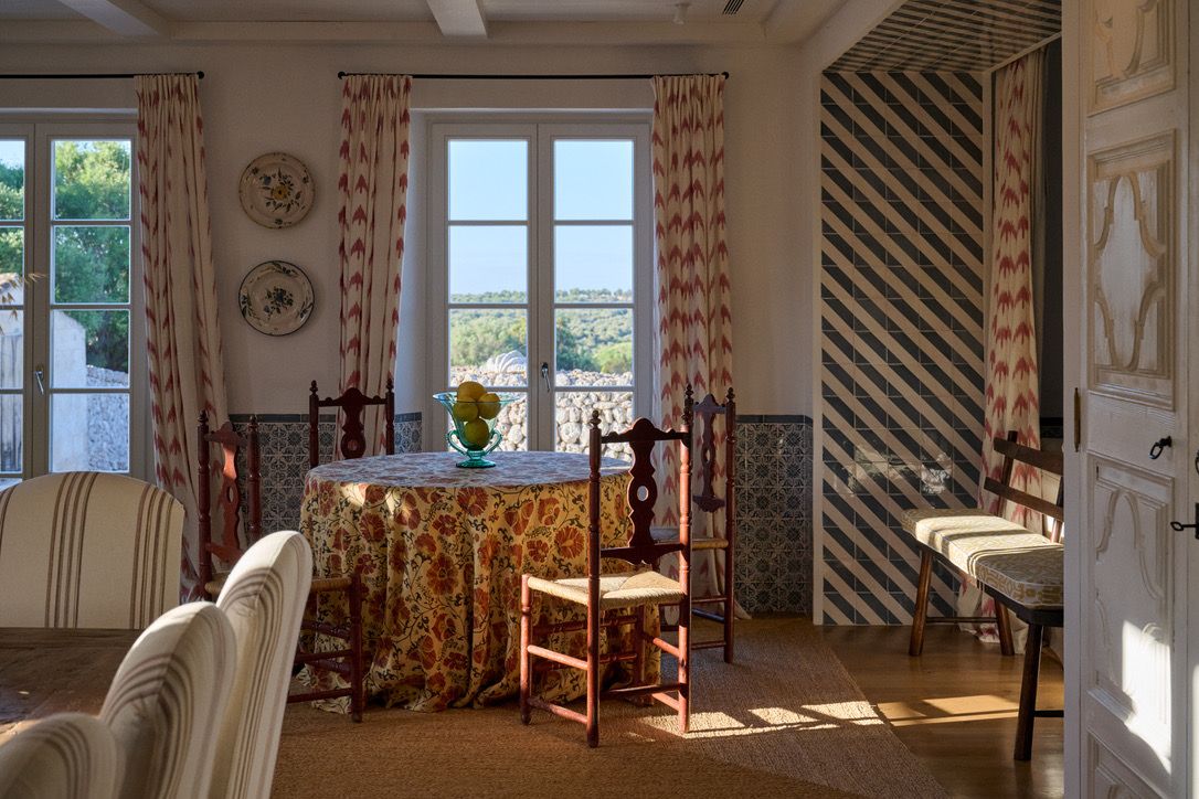 The breakfast room, its round table dressed and the walls tiled to the dado