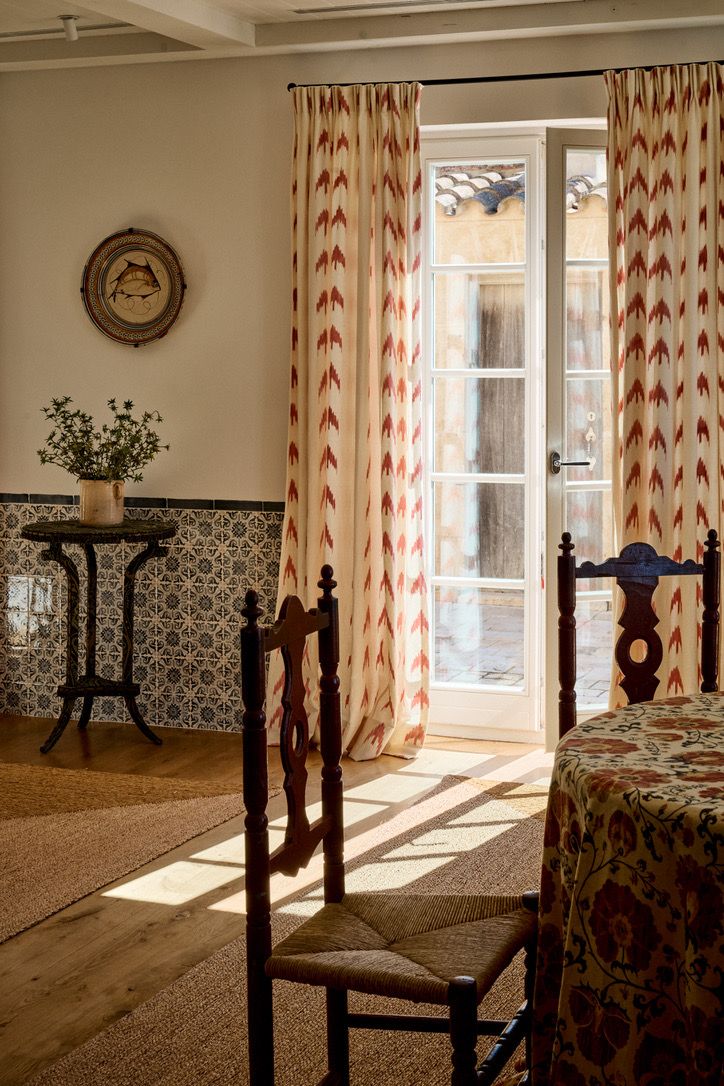 A french door to the courtyard framed by ikat curtains