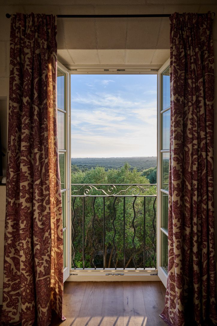The view over the treetops through a bedroom balcony door