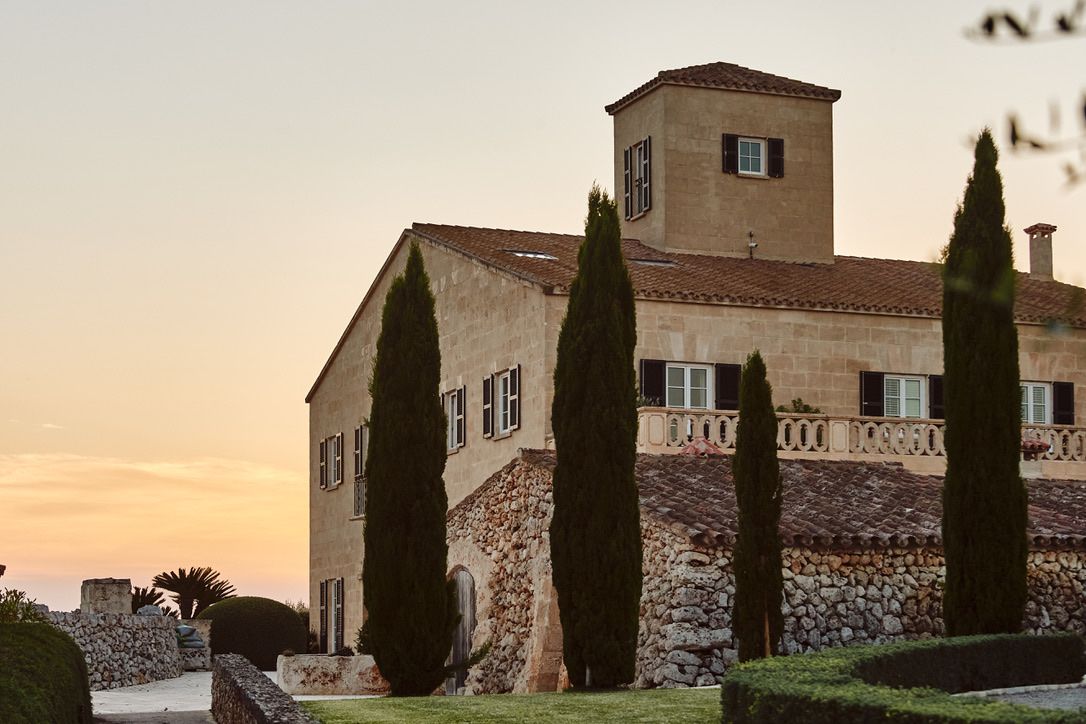 The house and its cypresses in the evening light